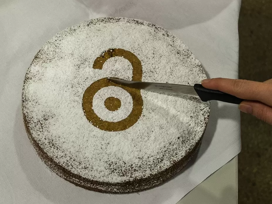 An image of an Open Access cake being sliced
